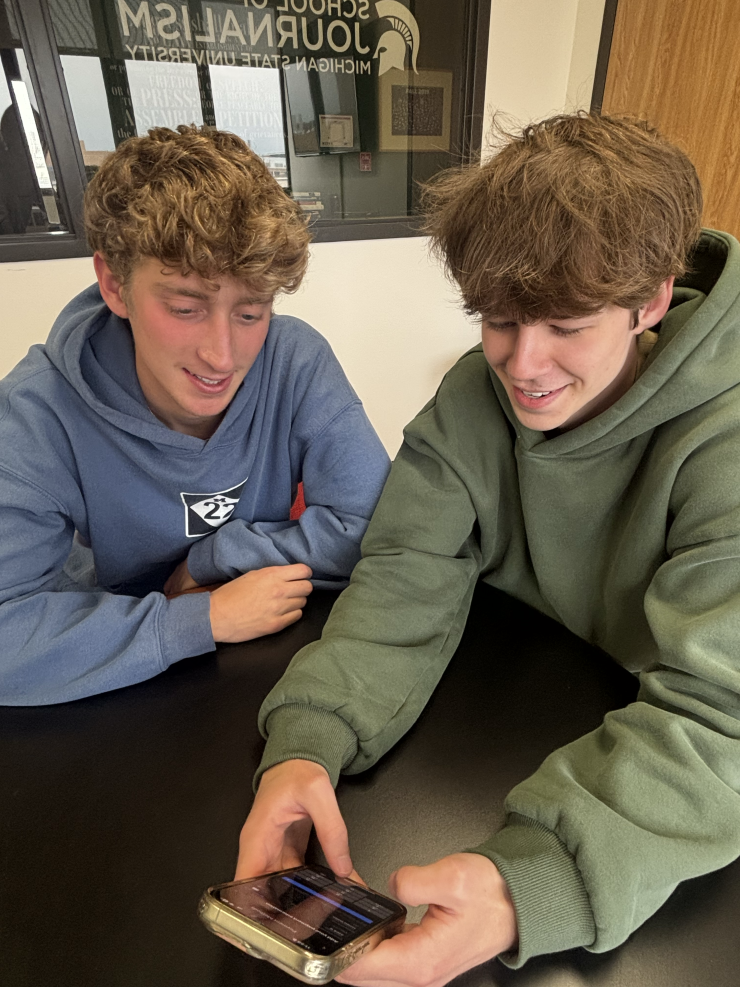 Two people look at a phone screen together