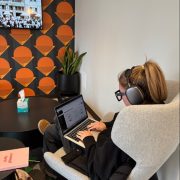 A person working at a laptop with headphones