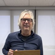 a man smiles holding an exhale card