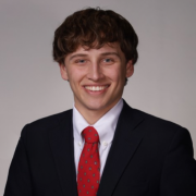 A man smiles for a portrait