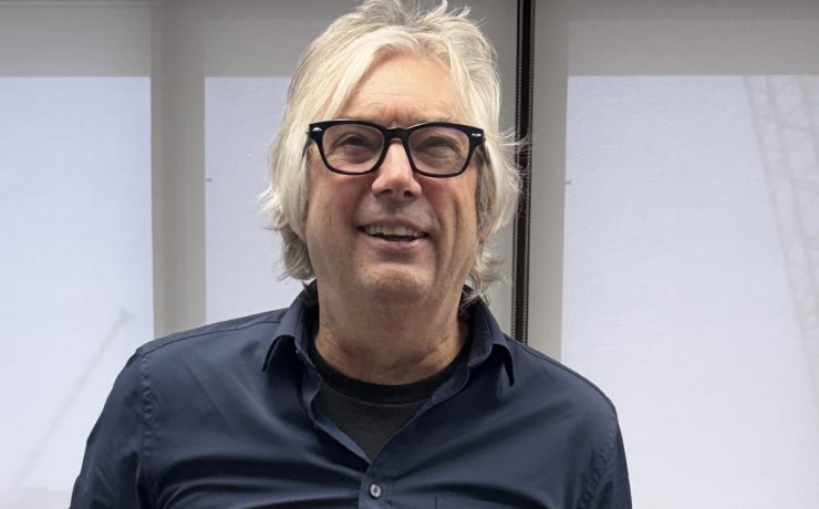 a man smiles holding an exhale card