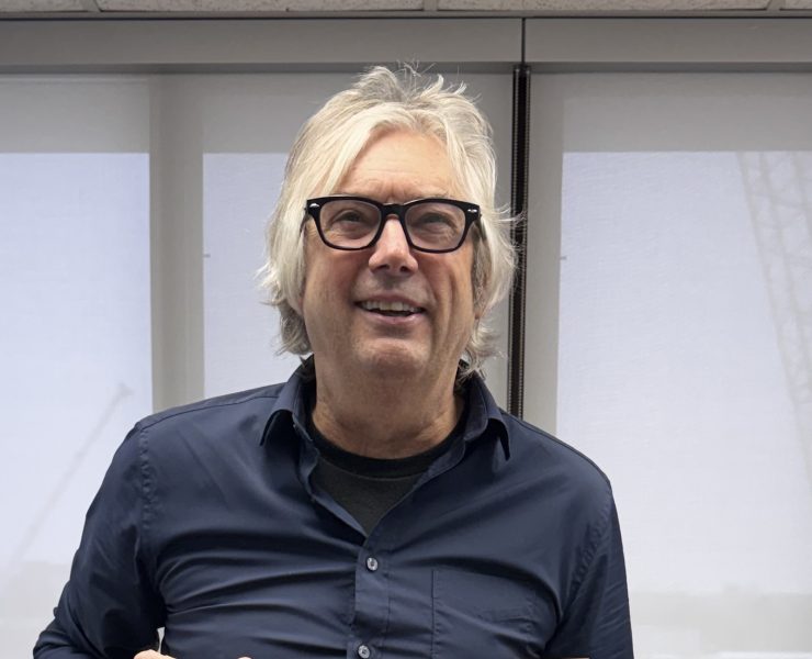 a man smiles holding an exhale card