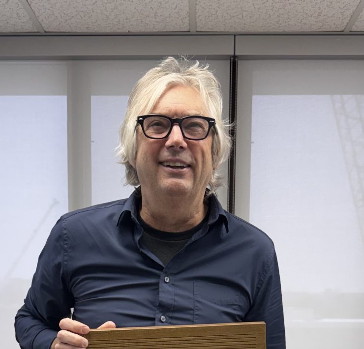 a man smiles holding an exhale card