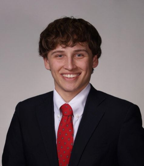 A man smiles for a portrait