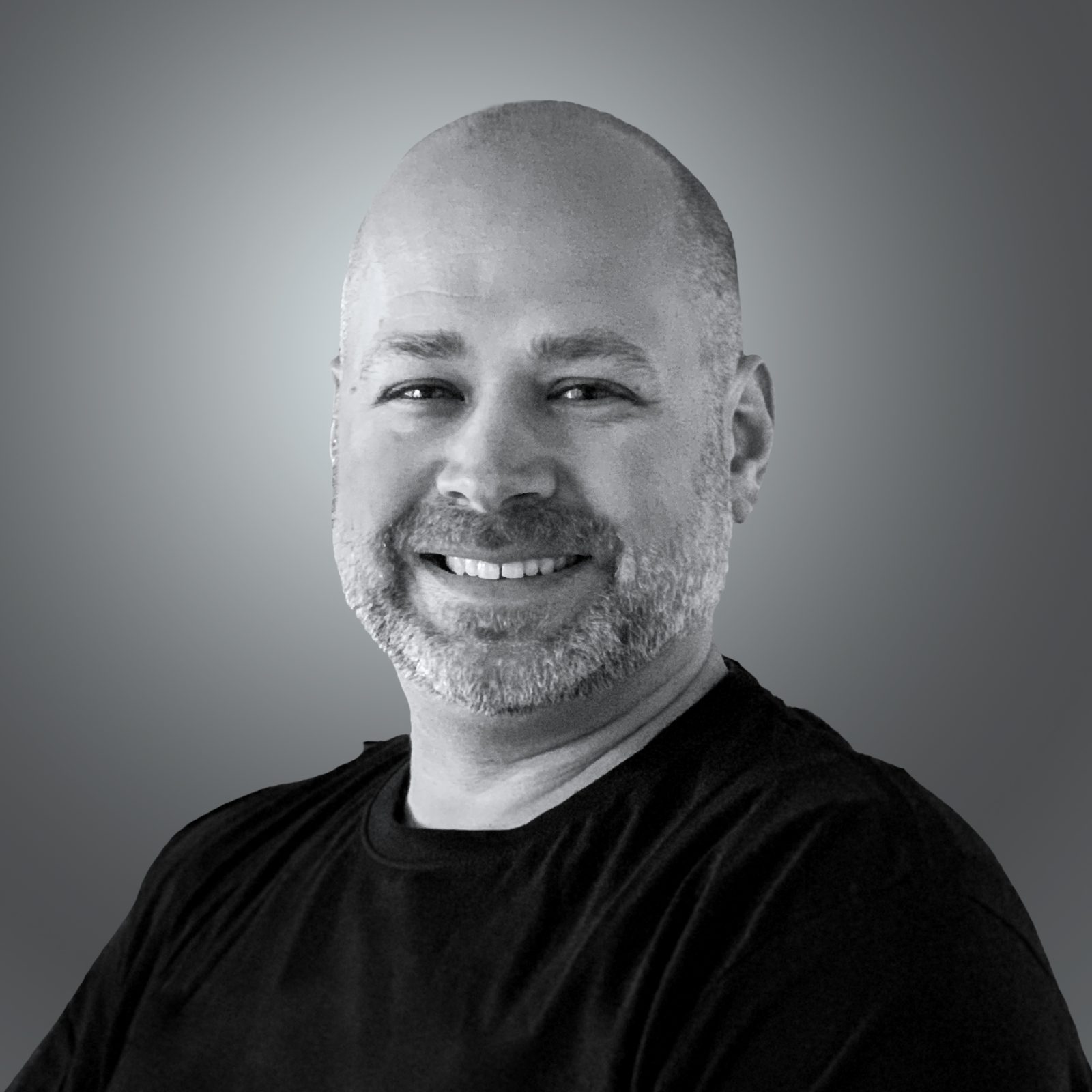 A person smiling on a gray background