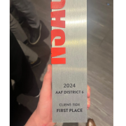 An physical award is held in the hand of a winner from MSU