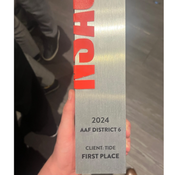 An physical award is held in the hand of a winner from MSU