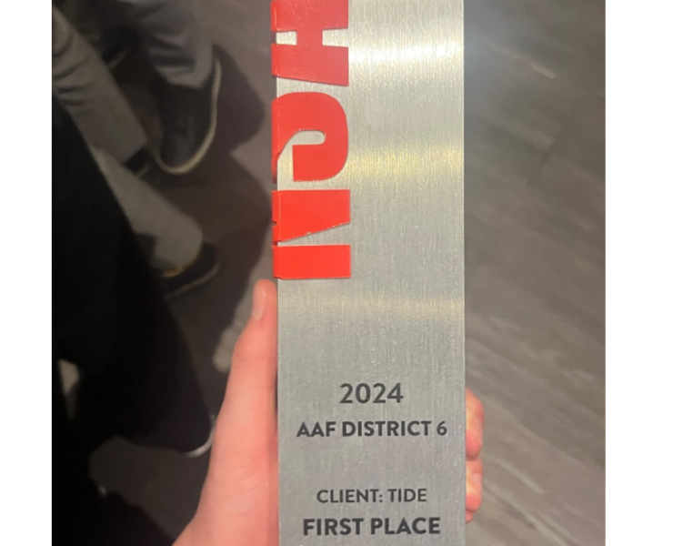 An physical award is held in the hand of a winner from MSU