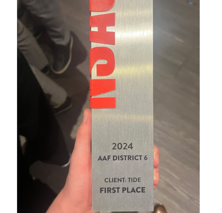 An physical award is held in the hand of a winner from MSU