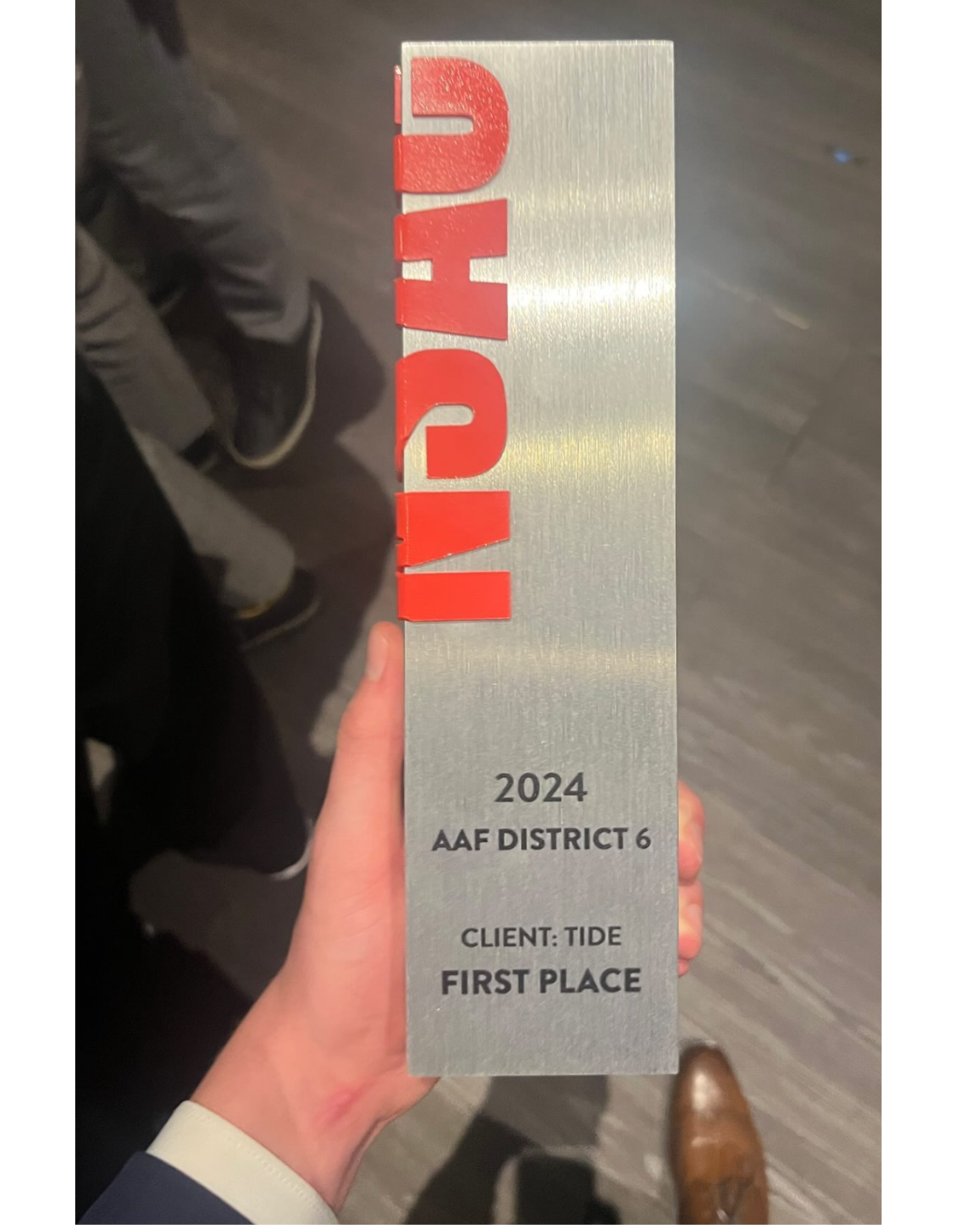 An physical award is held in the hand of a winner from MSU