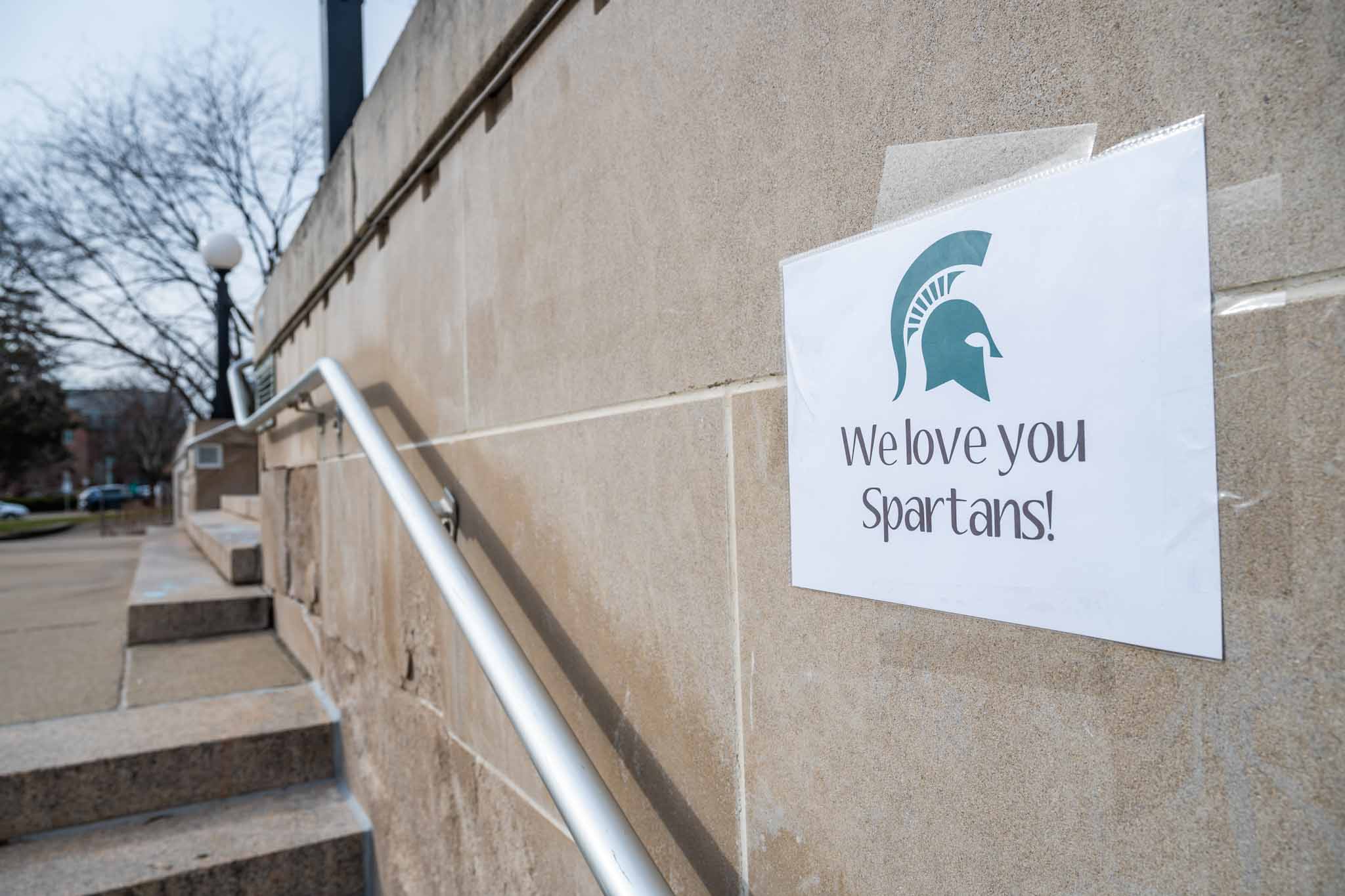 Exterior photograph of poster saying, "We Love You, Spartans!"